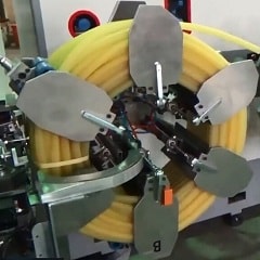 Hose coiling and strapping machine