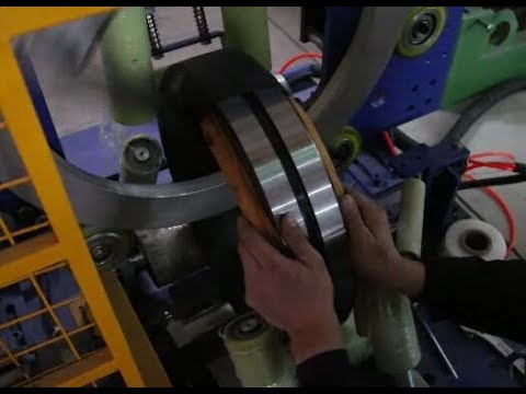 Bearing packing machine and wrapping machine with rubber bar packing