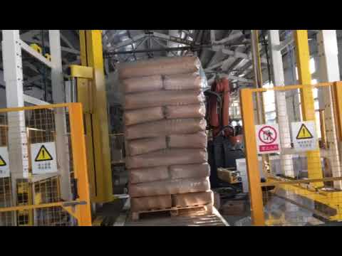 rotary arm pallet wrapping machine with top sheet film covering