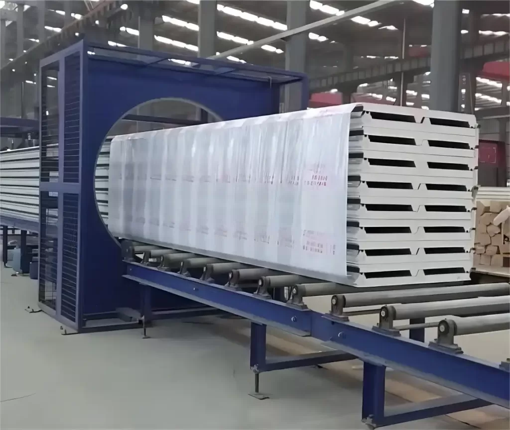 Horizontal stretch wrapping machine wrapping large panels, demonstrating industrial packaging process