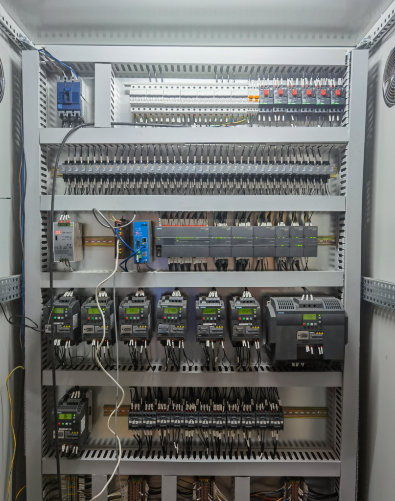 Detailed view inside an electrical control box for industrial packaging machinery.