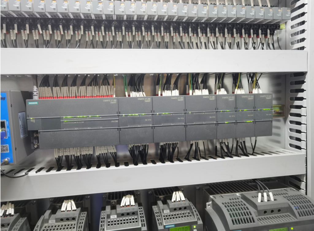 Electrical control cabinet for an automated coil packaging line, showing internal components.