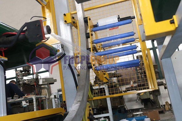Orbital stretch wrapper tension control Orbital stretch wrapper tension control