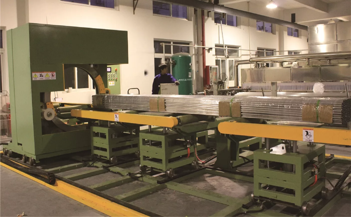 Horizontal orbital stretch wrapper securing long industrial products