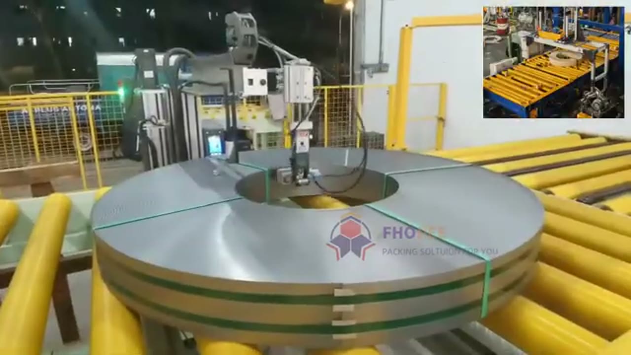 Steel coil on powered rollers secured with two bands near the end of the reviewed clip