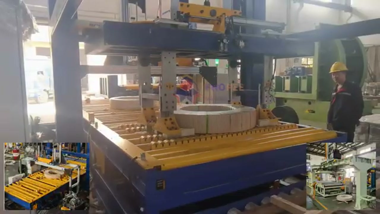 Horizontal steel coil on the rotating platform of a packaging machine, wrapped in clear stretch film